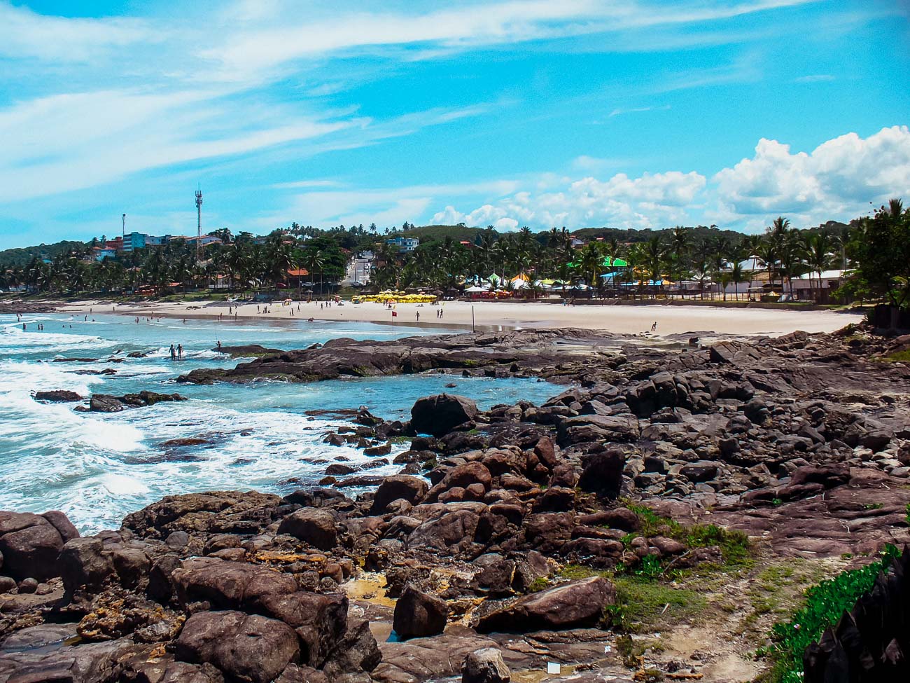 Praia da Batuba em Ilhéus com várias pedras em uma parte da areia