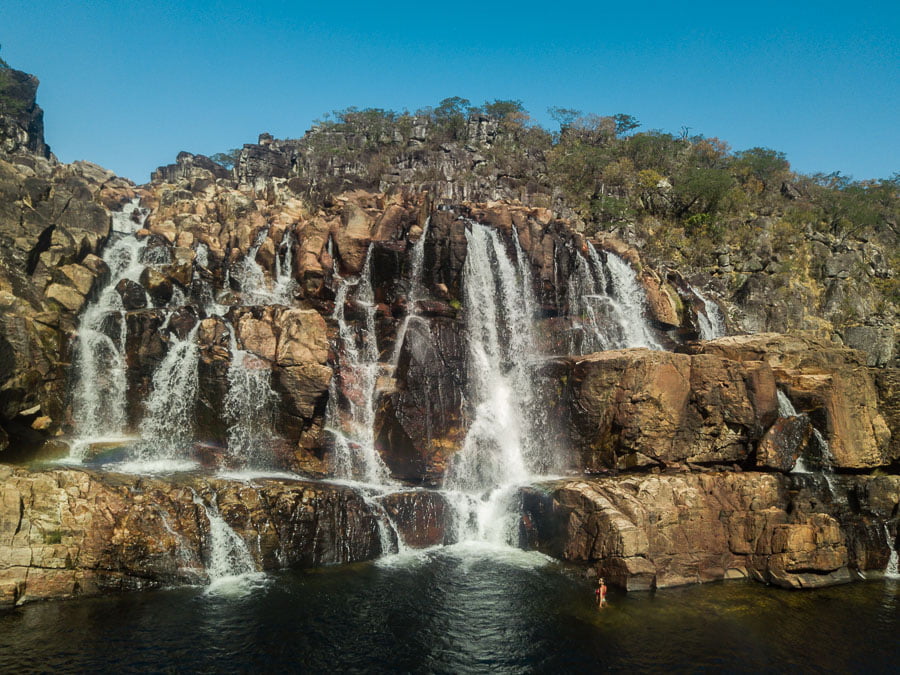 Extensa queda d'água sobre formações rochosas da Cachoeira Cariocas