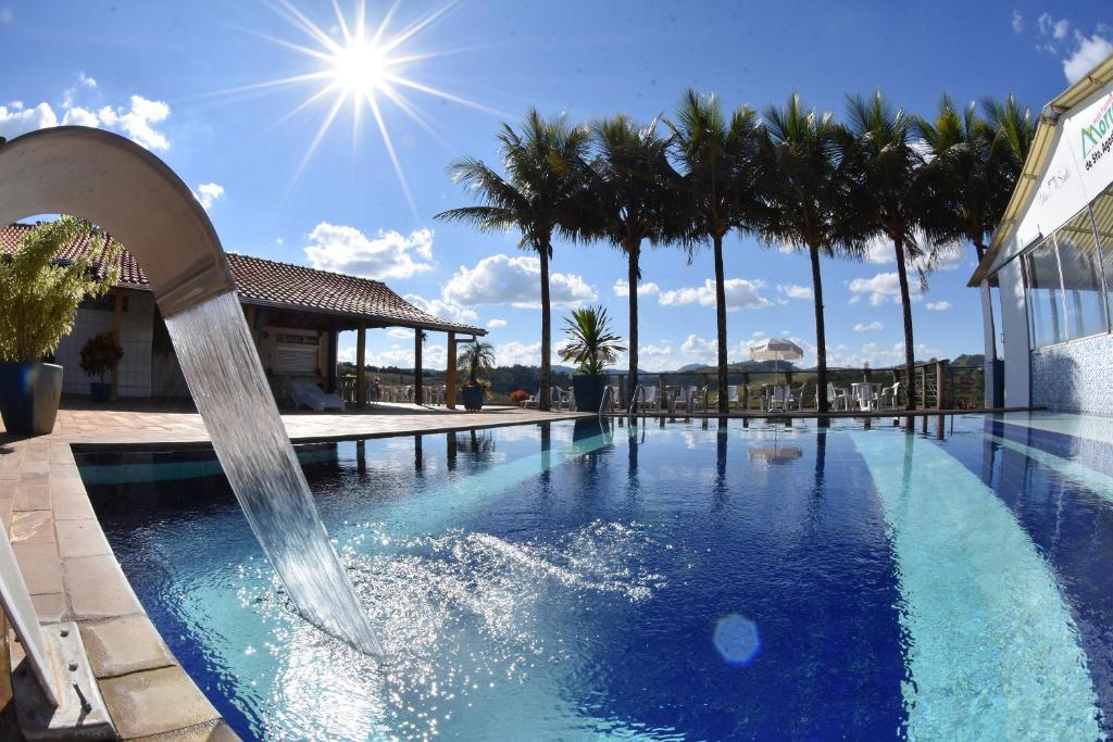 Piscina ao ar livre com cascata e vista para a natureza