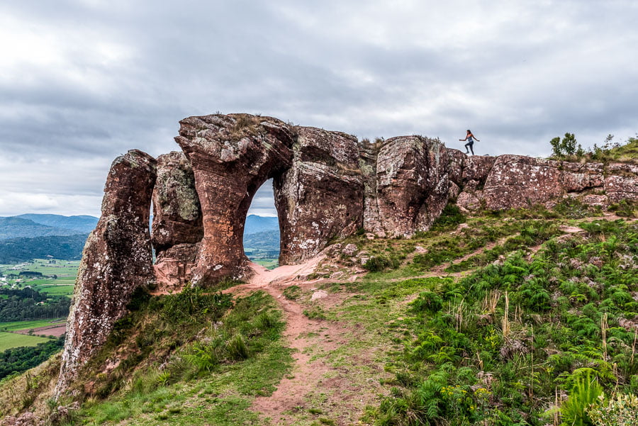 Uma mulher caminhando em direção ao topo do Morro do Campestre em Urubici