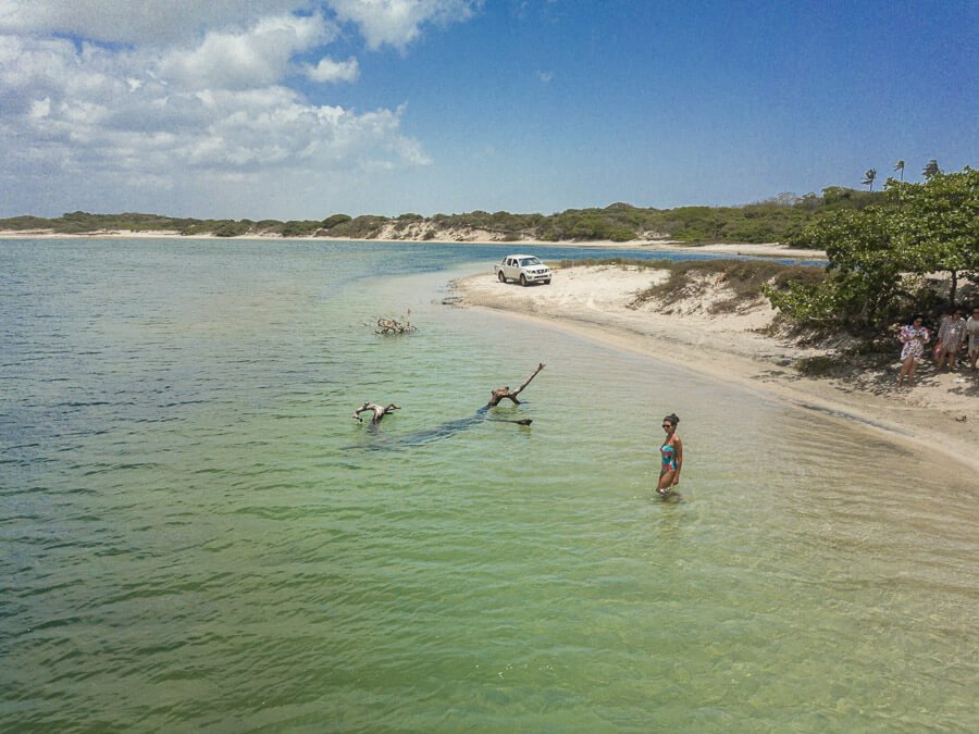 Lagoa do Paraíso em Jericoacoara de águas esverdeadas cristalinas e uma mulher na água.