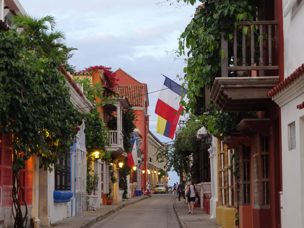 Rua no bairro San Diego, em Cartagena. Há árvores e casa coloridas.