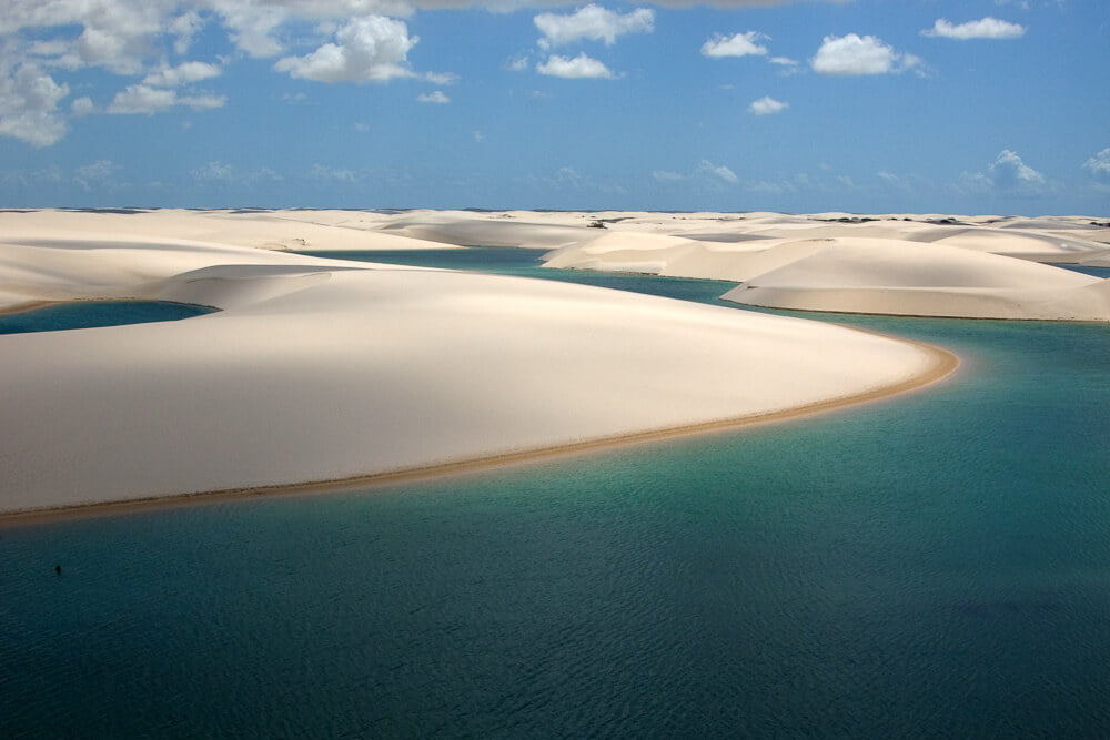 Lagoa Bonita, com caminhos sinuosos, águas verdes e dunas claras.