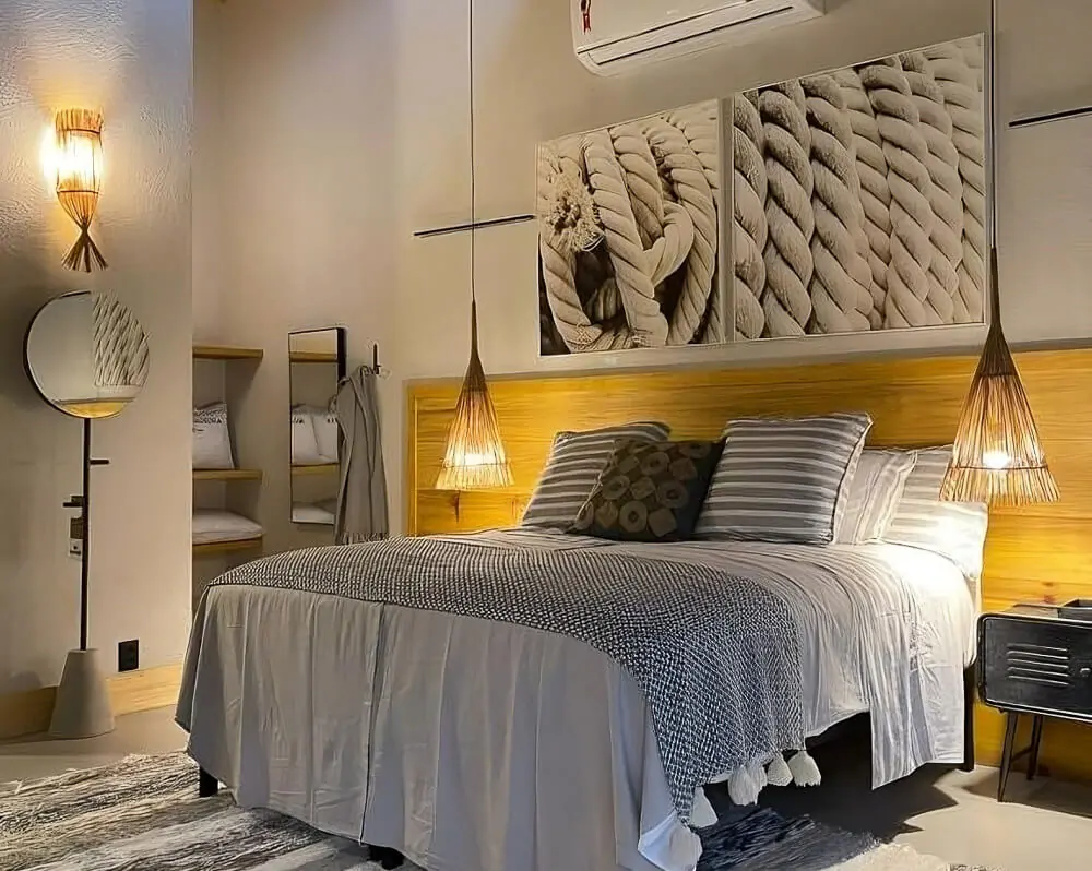 Quarto da Pousada Chácara Aracê, com cama de casal e iluminação aconchegante.