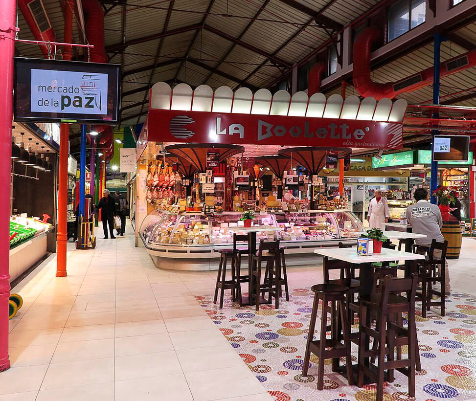 O Mercado de La Paz em Madrid, um famoso mercado coberto no bairro de Salamanca, com diversas bancas oferecendo produtos frescos e especiais.