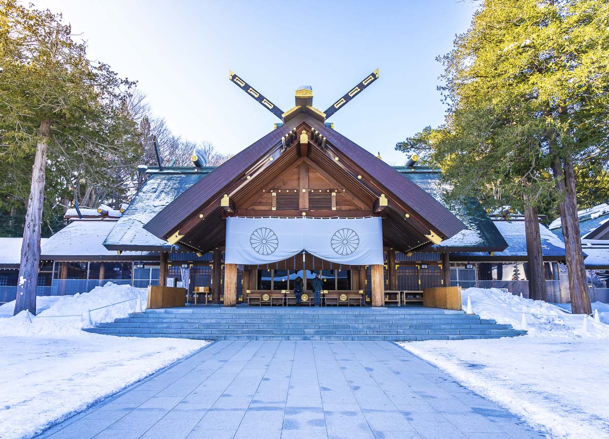 Hokkaido Jingu em Sapporo durante o inverno, com neve no chão e fachada de madeira.