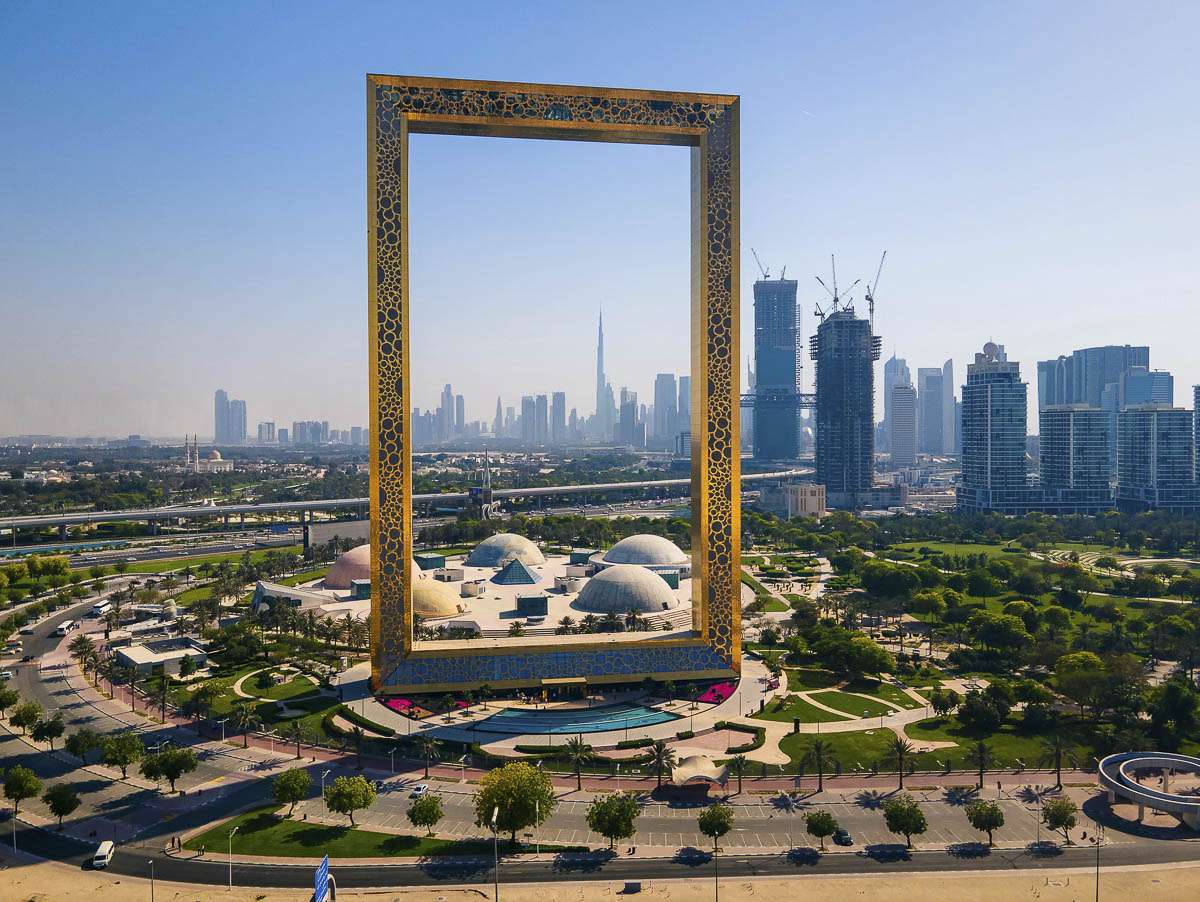 Dubai Frame em Dubai, moldura dourada gigante com o skyline da cidade ao fundo e o Burj Khalifa ao centro.