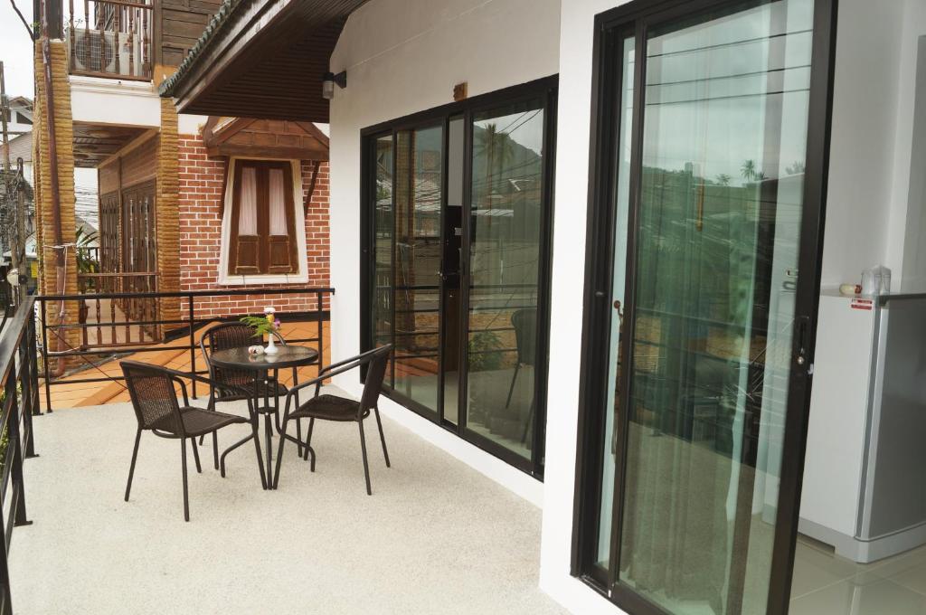Varanda do The Seashore Kamala Service Apartment em Phuket com mesa e cadeiras
