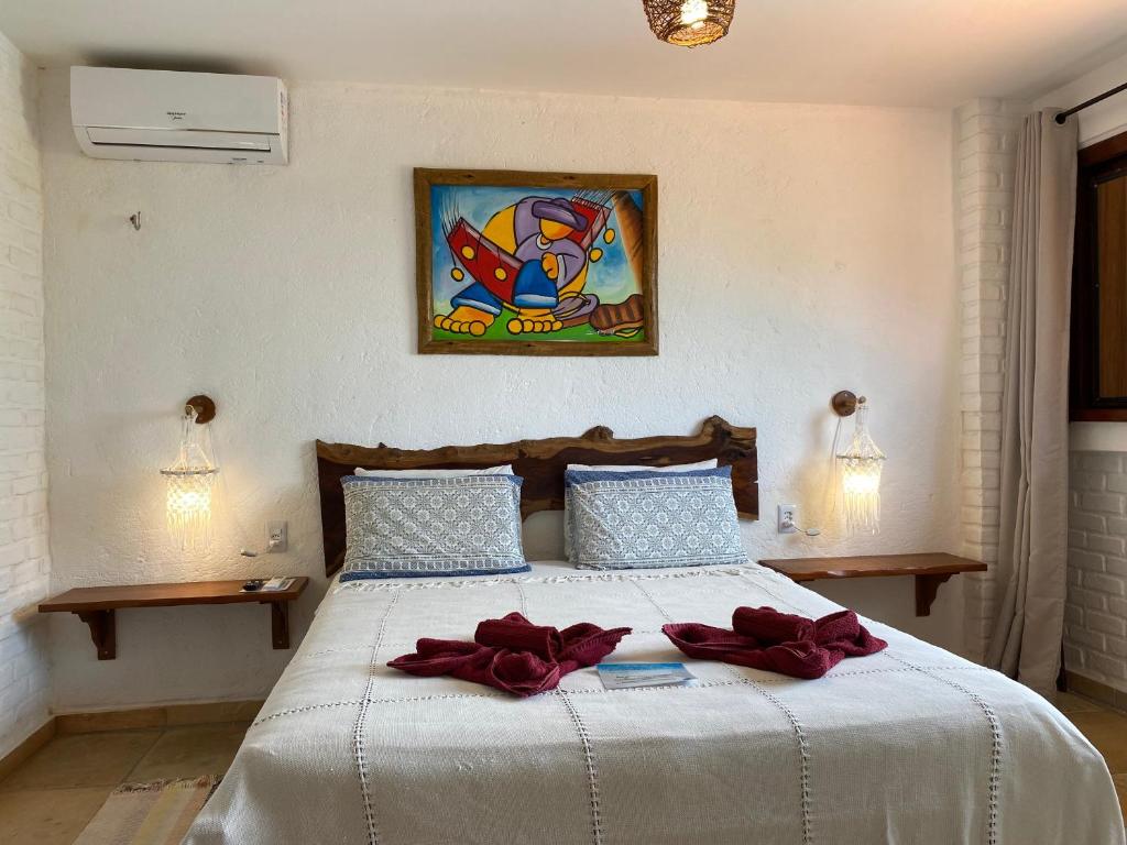 Quarto do Hotel Pousada Beleza das Ondas em Cumbuco com decoração artesanal
