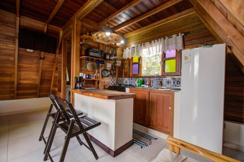 Chalé da Pousada e Hostel Pé no Mato na Chapada Diamantina com cozinha equipada em madeira.