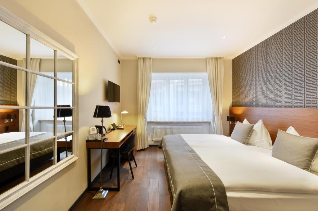 Quarto do Hotel City Zürich Design & Lifestyle, em Zurique, com decoração elegante.