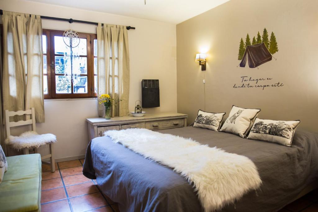 Quarto do Llao Llao Resort, Golf & Spa, em Bariloche, com cama de casal e janelas voltadas para a natureza.