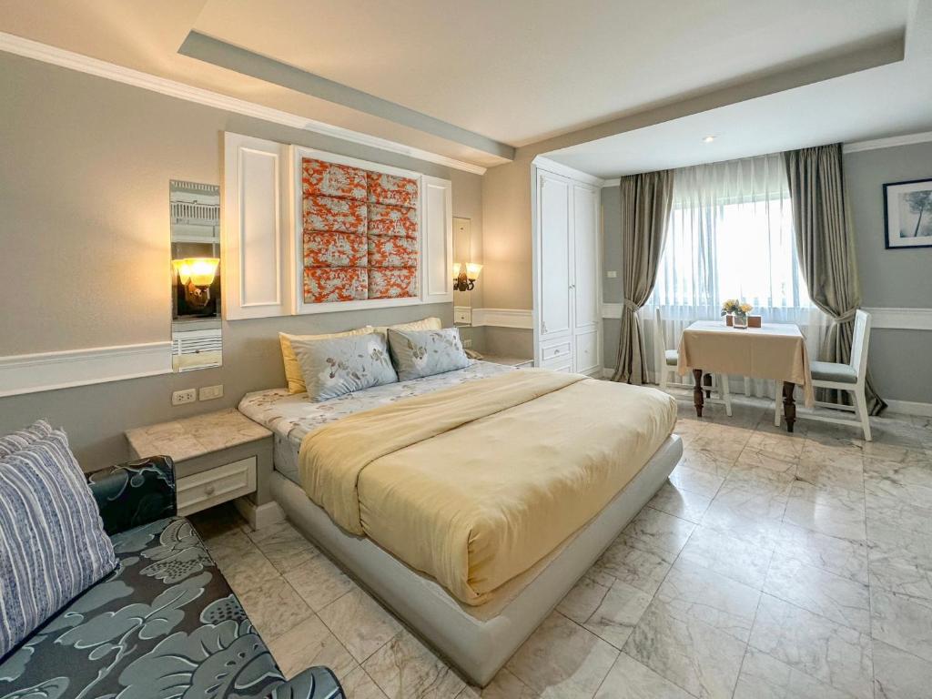 Quarto elegante com colcha amarela e mesa de apoio em Chiang Mai.