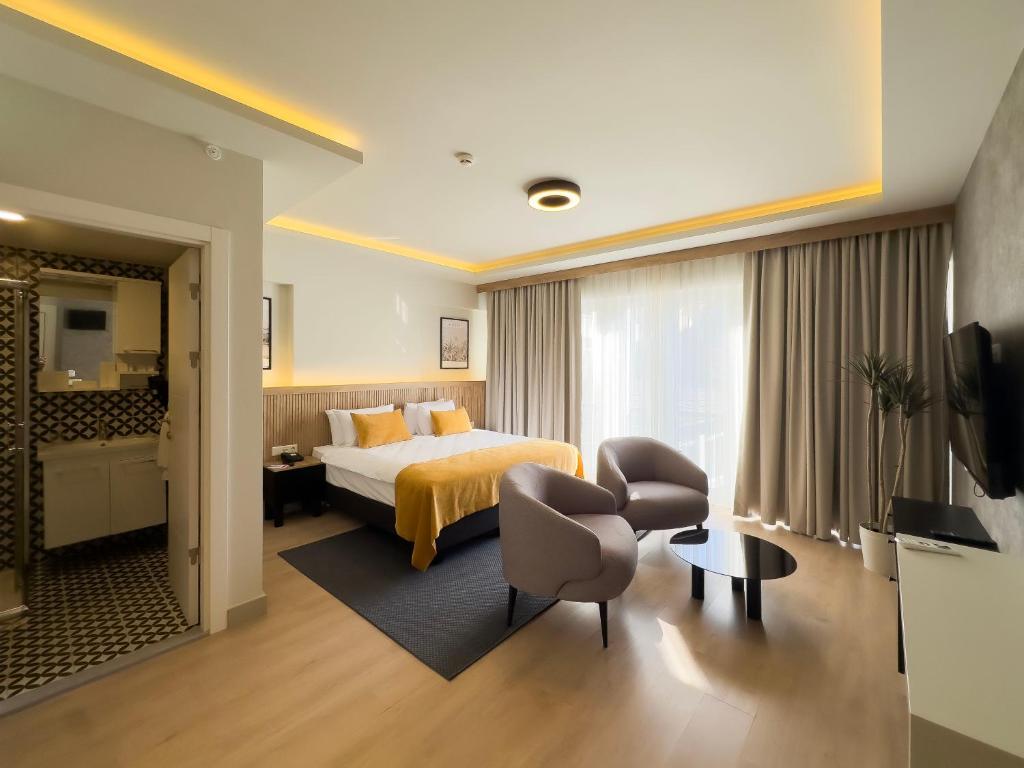 Acomodação do Dugi, em Istambul, com cama de casal, duas poltronas e banheiro integrado.
